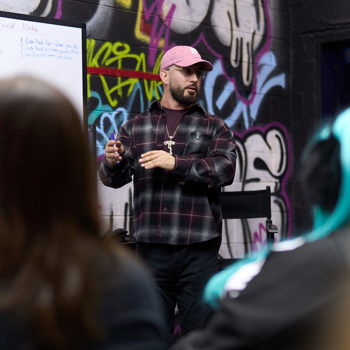 workshop presenter speaking to a small group at crack house studios