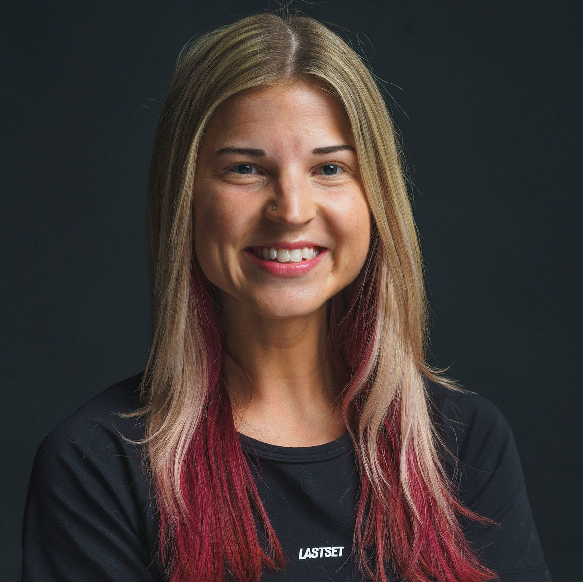 professional studio headshot with consistent lighting and a dark background