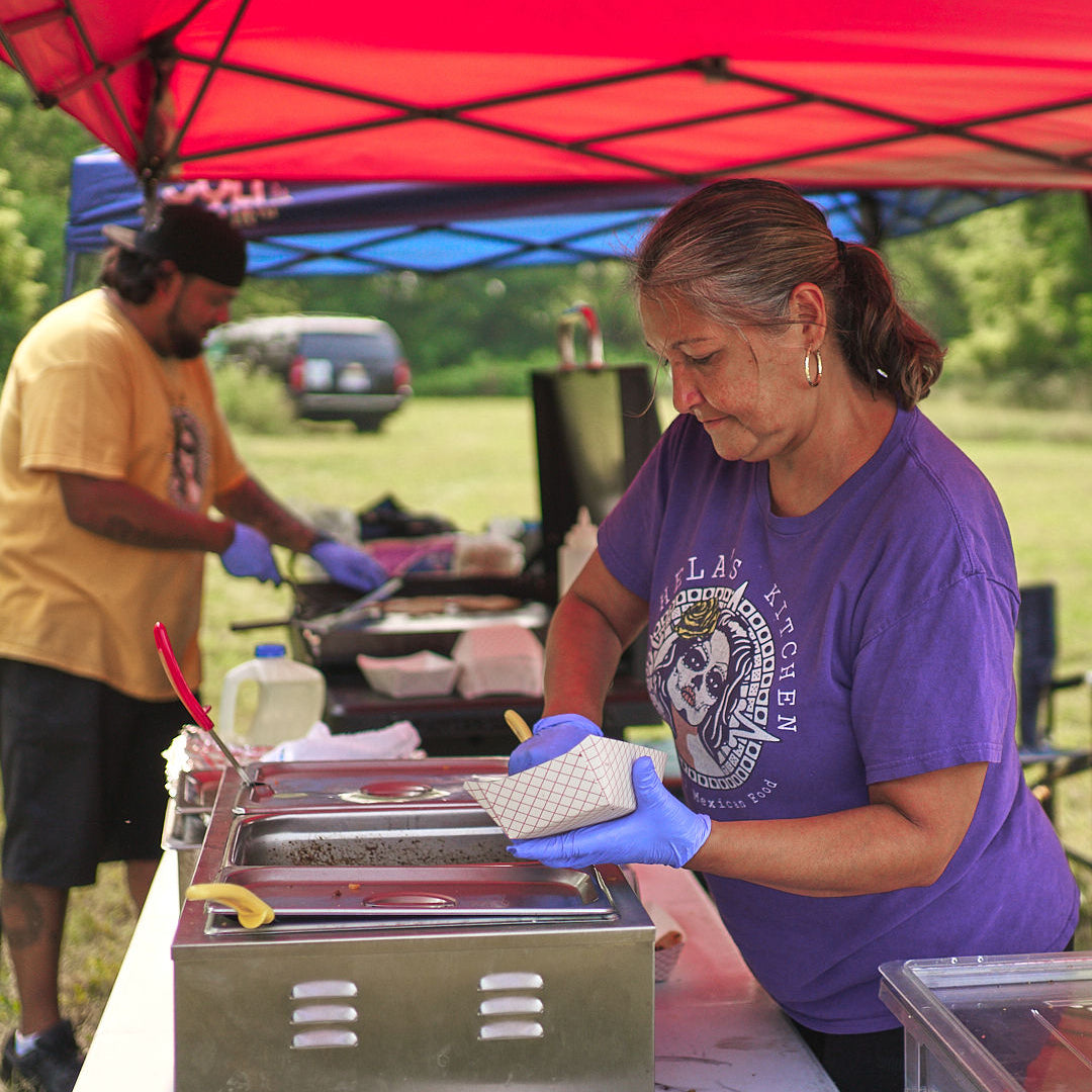 vendor serving guests during a Lansing community event